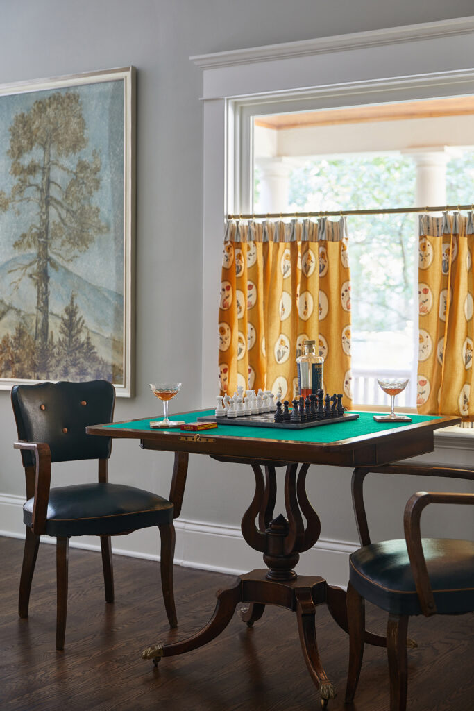 A vintage game table area by Meghan Jay Design, a residential interior designer based in Chicago.