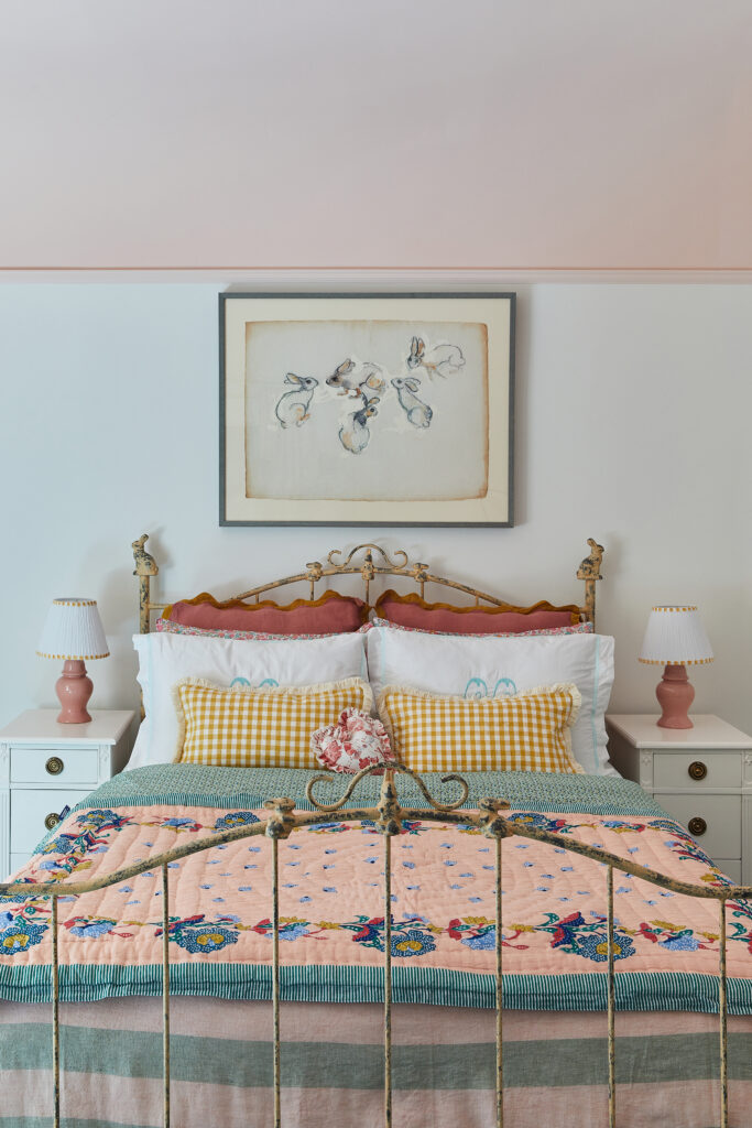 Interior designer Meghan Jay's daughter's room, featuring a bed and bunny art from an estate sale.