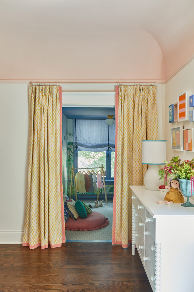 A little girl's dream bedroom, featuring bright pops of color and a dress-up nook.